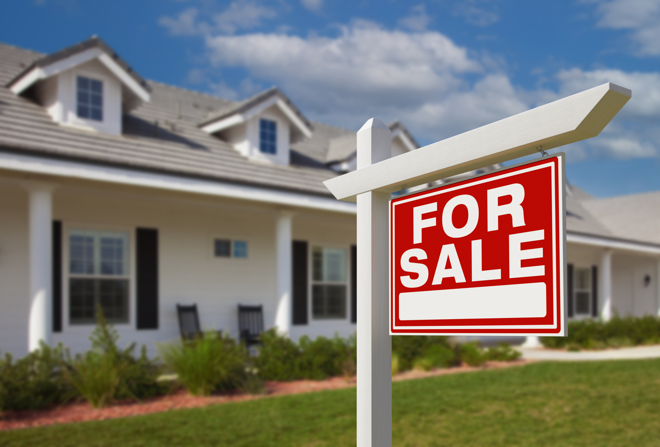 A house with a for sale sign out front.